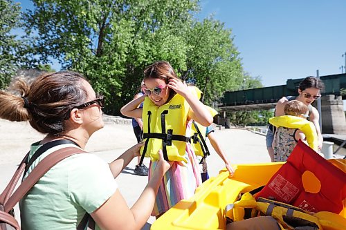 Ruth Bonneville / Free Press
Standup - Forks River Tour
Six-year-old Amelia Manson has her life jacket buckled up by her mom Colleen Manson as the extended family gets ready to head out on a Winnipeg Waterways tour boat at the Forks docks Monday.
Amelia’s brother, Max Manson (8yrs) is behind her and their cousin Henry Nimchuck (4yrs() along with other extended members of the family prep for the trip, behind them.
Winnipeg Waterways offers scenic river boat tours and seasonal water bus transit along the Red and Assiniboine Rivers, departing from The Forks Historic Port. The Water Bus ends Sept 13 but the tour boats will be running until Oct 4th this year.
Aug 28th,, 2026