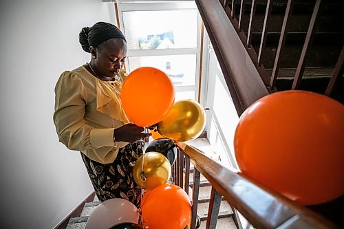 MIKAELA MACKENZIE / FREE PRESS
	
Grace Kilani puts balloons in the stairwell at the newly renovated Native Addictions Council of Manitoba grand re-opening on Tuesday, Sept. 1, 2026.

For Scott story.
Free Press 2026