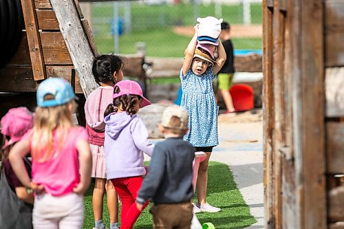 MIKAELA MACKENZIE / FREE PRESS
	
Olivia (six) plays with sun hats as minister Tracy Schmidt makes a child care announcement at Panda Bear Day Care on Wednesday, Sept. 2, 2026.

For Nicole story.
Free Press 2026