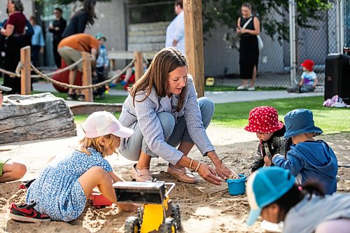 MIKAELA MACKENZIE / FREE PRESS
Minister Tracy Schmidt plays in the sandbox with children after making a child care announcement at Panda Bear Day Care on Wednesday, Sept. 2, 2026.
For Nicole story.
Free Press 2026