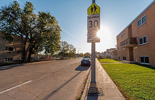 MIKE DEAL / FREE PRESS
The sign that instructs drivers they are entering a 30km/hr zone is backlit by the sun  along Talbot Avenue right before the intersection with Watt Street next to River Elm School.
The stretch of Talbot Avenue including the intersection with Watt Street is one of the top 10 most ticketed school zones (30 km/h) in 2024-25.
Reporter: Maggie Macintosh
250925 - Thursday, September 25, 2025.