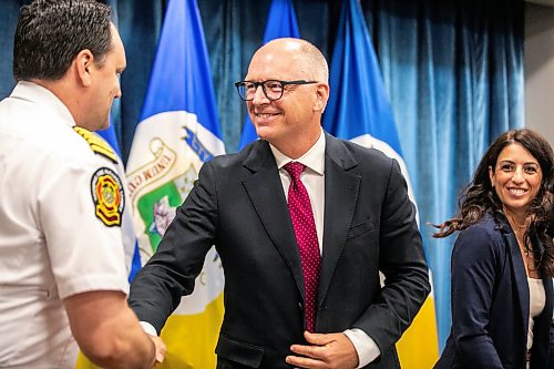 MIKAELA MACKENZIE / FREE PRESS
	
Mayor Scott Gillingham (right) shakes hands with Winnipeg Fire Paramedic Service chief Ryan Sneath at the release of the Community Crisis Response report on Tuesday, July 28, 2026.

For Malak story.
Free Press 2026