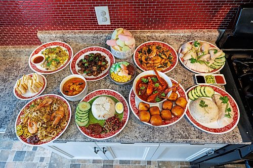 MIKE DEAL / FREE PRESS
Malvin Soh is busy prepping for his pop-up restaurant Sedap Singapore Kitchen. Soh is excited to introduce Winnipeggers to the spicy, complex and delicious flavours of the small island nation.
(Clockwise from top left) Orh Luak, Chai Tow Kway, Prawn Keropok, Cereal Prawn, two plates of Hainanese Chicken Rice (soy paste, scallion ginger, chili sauce), Singapore Chili Crab, Ice Kachang, Nasi Lemak, Sambal Prawns, Hokkien Prawn Mee, and Kaya Toast.
Reporter: AV Kitching
260910 - Thursday, September 10, 2026.