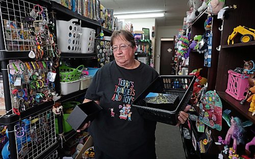 Ruth Bonneville / Free Press
Local Terri’s Pokeman theft
Photo of Terri Settle, owner of Terri’s Trinkets and Toys, says the thieves stole thousands of dollars worth of Pokemon cards along with other higher-end items this week.
POKEMAN THEFT: Another collectibles shop in Winnipeg has been hit by thieves seeking Pokémon cards. Terri Settle, owner of Terri’s Trinkets and Toys, said she arrived at her shop Wednesday and discovered thieves had smashed a hole in her wall to get at the cards.
Story by SCOTT B
Sept 11th, 2026