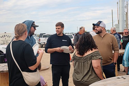 Westman Lumber Supply general manager Kevin Fast talks to customers during the company's 10th year anniversary celebration on Friday afternoon. (Abiola Odutola/The Brandon Sun)