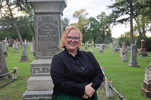 Margaret “Maggie” Stewart McMillan, portrayed by Sarah Hay, stands by Alexander Fleming's grave during the Gossip in the Graveyard event at the Brandon Municipal Cemetery on Saturday evening. Maggie told visitors about her husband, Archibald McMillan, Brandon’s first chief of police. Photos: Abiola Odutola/The Brandon Sun