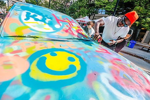 JOHN WOODS / FREE PRESS
John Amaglo has fun painting a car as people participate in The Weekender Street Festival on Graham Ave Sunday, September 13, 2026.

reporter: standup