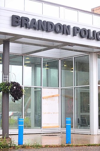 The Brandon Police Service headquarters sports a boarded up window on its front entrance after a man wielding a sledgehammer broke it over the weekend. (Matt Goerzen/The Brandon Sun)