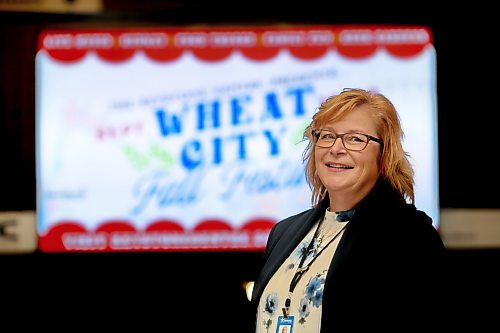 Keystone Centre CEO Connie Lawrence poses for a picture in front of a video sign advertising the Wheat City Fall Festival, coming up this weekend. (Matt Goerzen/The Brandon Sun)