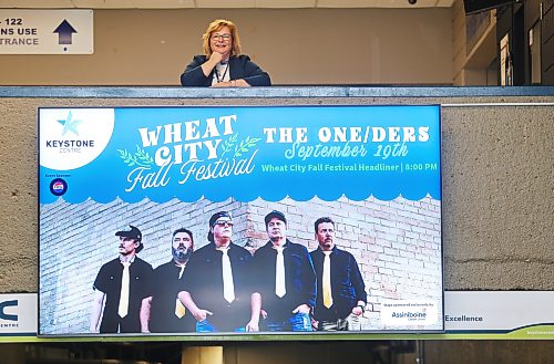 Keystone Centre CEO Connie Lawrence poses for a picture on the balcony above a video sign advertising the Wheat City Fall Festival, coming up this weekend. (Matt Goerzen/The Brandon Sun)