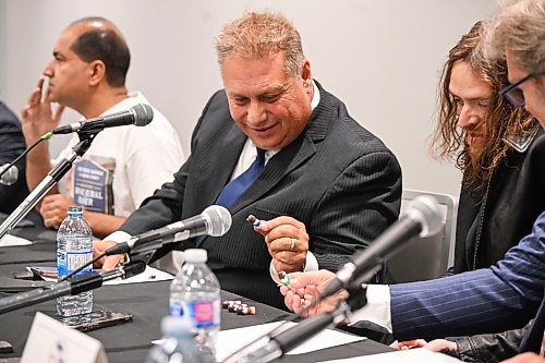 Mike Sudoma/Free Press
Mayoral Candidate Johnny Calderon gives opponent Mike Vogiatzakis a Jesus mini figure prior to the Mayoral Debate at Union Centre held by the Amalgamated Transit Union Monday evening 
September 14, 2026


