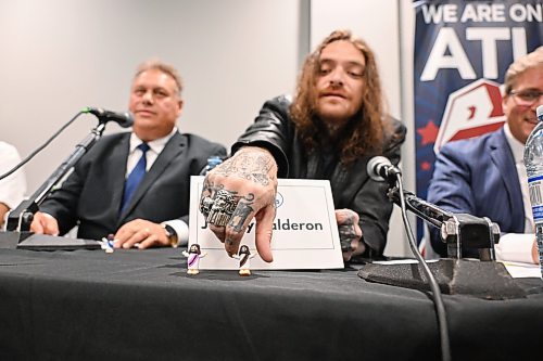 Mike Sudoma/Free Press
Mayoral Candidate Johnny Calderon places a Jesus min figure infant of his name card during the Mayoral Debate at Union Centre held by the Amalgamated Transit Union Monday evening
September 14, 2026