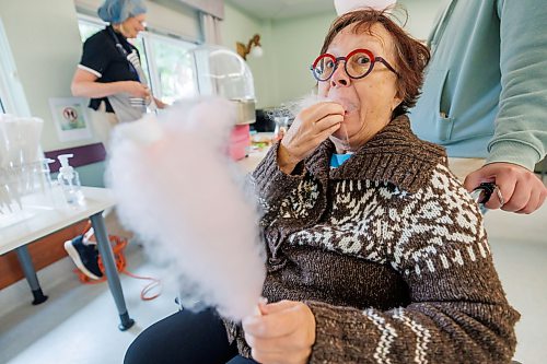MIKE DEAL / FREE PRESS
Dawn Reynoldson enjoys some cotton candy  during the Misericordia Place personal care home’s first-ever block party.
Dawn is a member of the community and lives a block away in Misericordia Terrace.
standup
260916 - Wednesday, September 16, 2026.