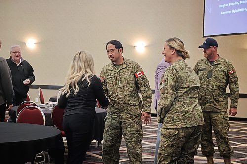 CFB Shilo commanding officer Jack Nguyen shakes hands with a member of the audience. Nguyen and several other military officials attended the event to provide information about upcoming work at CFB Shilo. (Connor McDowell/The Brandon Sun)