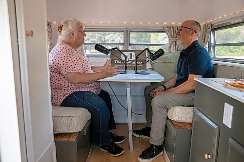 BROOK JONES/FREE PRESS
David Balzer, 60, has converted his Triple E Surfside camper trailer called Chatterbox into a mobile recording studio in which he records people's stories of gratitude and belonging. The associate professor of communications and media at Canadian Mennonite University was at the Elim Mennonite Church in Grunthal, Man., to record stories from varous church members on Sunday, Sept. 13, 2026. Pictured: Chatterbox producer David Balzer (right) interviews Wanda Woelke, 65.