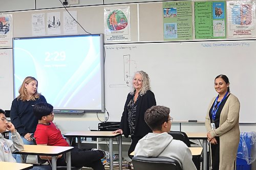 Brandon School Division assistant superintendent of student services Susan Gilleshammer (centre) talks to Vincent Massey High School students during an after-school tutoring and mentoring program on Friday afternoon, while North Star Project project facilitator Katey Rogowsky (left) and student-parent support worker Mitalben Gadhavi look on. (Abiola Odutola/The Brandon Sun)