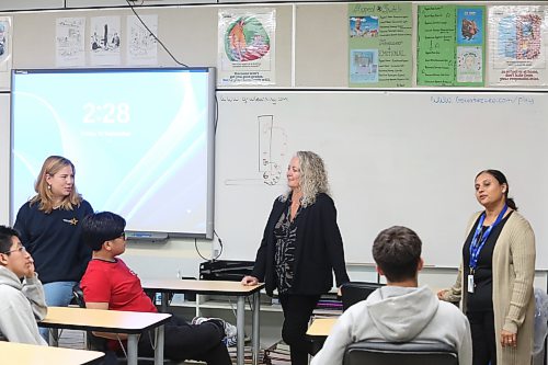 Brandon School Division assistant superintendent of student services Susan Gilleshammer (centre) talks to Vincent Massey High School students during an after-school tutoring and mentoring program on Friday afternoon, while North Star Project project facilitator Katey Rogowsky (left) and student-parent support worker Mitalben Gadhavi look on. (Abiola Odutola/The Brandon Sun)