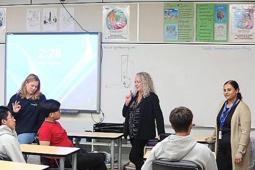 Brandon School Division assistant superintendent of student services Susan Gilleshammer (centre) talks to Vincent Massey High School students during an after-school tutoring and mentoring program on Friday afternoon, while North Star Project project facilitator Katey Rogowsky (left) and student-parent support worker Mitalben Gadhavi look on. (Abiola Odutola/The Brandon Sun)