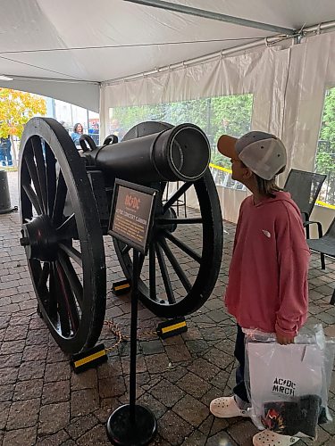 Sheldon Birnie / Free Press
A young fan inspects the cannon at the AC/DC PWR/UP pop up on Friday at the Pyramid Cabaret.