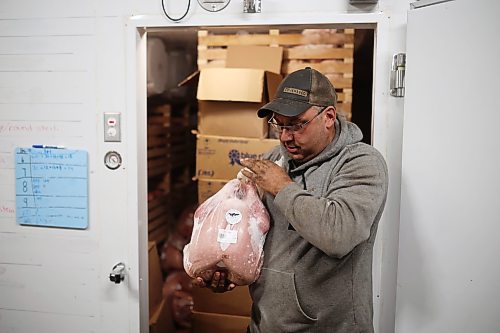 18092026
Brian Blanchard with Evergreen Alley Farms south of Boissevain takes a frozen turkey for sale out of the freezer at his farm on Friday. Blanchard and his partner Alicia Dyck raised 100 turkeys this year for sale. (Tim Smith/The Brandon Sun)