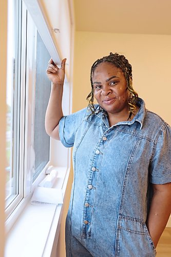 Zeenat Oyetunjai lets natural light into the upstairs living room of her home in Brandon. Oyetunjai was selected by Habitat for Humanity for its affordable homeownership program. Oyetunjai lives there with her daughter, son, and mother. (Rylee Gerrard/The Brandon Sun)