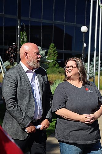 Tyson Tame, campaign chair, with Cynamon Mychasiw, chief executive officer of United Way West Central Manitoba, chat after the flag-raising ceremony at Brandon City Hall on Monday to announce the fundraising goal for the 2026 "Planting Possibilities" campaign. (Rylee Gerrard/The Brandon Sun)