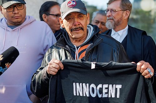 MIKE DEAL / FREE PRESS
Clarence Woodhouse holds up a t-shirt that says “Innocent” on it to the media as he leaves court with family and his lawyers after being acquitted and declared innocent of the killing that took place in Winnipeg in 1973.
Reporter: Katrina Clarke
241003 - Thursday, October 03, 2024.