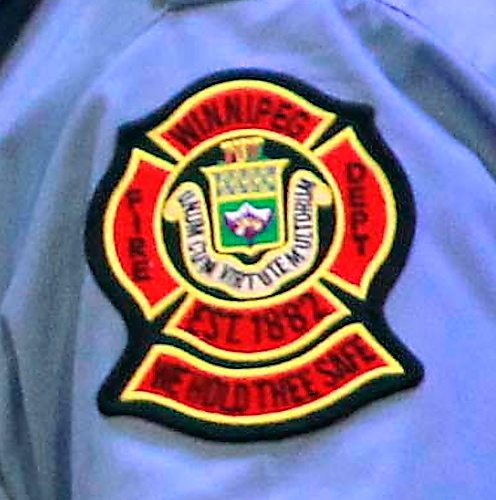 BORIS MINKEVICH / WINNIPEG FREE PRESS
FIRE GRAD 1801 - From left, WFPS Chief John Lane watches WFPS retired firefighter Gary Oakley present his son Ted with his badge #2501 at The Metropolitan Entertainment Centre this afternoon. 16 new recruits graduated today. April 13, 2018
