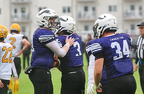 Cash Laluk (left), congratulates wide receiver Haiden Samuels during the Vincent Massey Vikings game against the Steinbach Sabres at Vincent Massey on Sept. 18. Laluk is in his final year playing football for the Vikings. (Rowan McCarthy/The Brandon Sun)