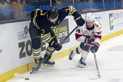 Brandon's Brady Turko tries to keep the puck away from Matt Paranych. (Tim Smith/The Brandon Sun)