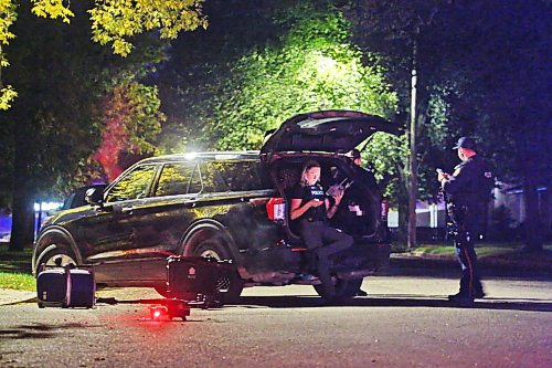 A drone operated by Brandon Police waits to take off from the ground on Whillier Drive in front several officers during an armed standoff late Thursday evening. Brandon police operated at least two drones over the course of the evening as they staked out a residence one street down on Creighton Boulevard. (Matt Goerzen/The Brandon Sun)