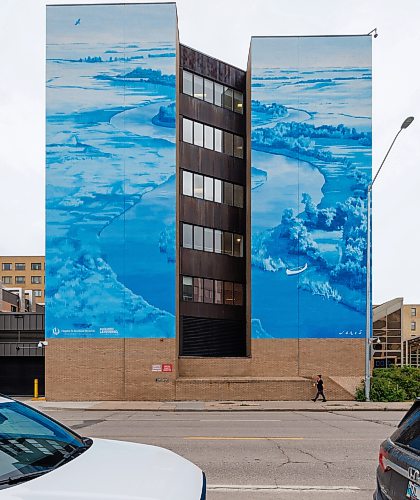 MIKE DEAL / FREE PRESS
Pedestrians walk along Taché past the brand new mural on the side of the St. Boniface Hospital Friday afternoon.
St. Boniface Hospital, St. Boniface Hospital Foundation, and the Higher Learning Foundation have unveiled a new large-scale mural on the front of St. Boniface Hospital today, bringing vibrant public art to Taché Avenue and celebrating the Hospital’s history, community, and commitment to fostering healing through the arts. 
Created by Canadian-born artist and muralist Emmanuel Jarus, the mural draws inspiration from the natural landscape of the Red River Valley and the heritage of the Grey Nuns, who arrived in the community by canoe more than 150 years ago and founded St. Boniface Hospital, establishing a tradition of compassionate care that continues today. 

Standup
260925 - Friday, September 25, 2026.