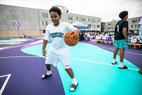 MIKAELA MACKENZIE / FREE PRESS
	
Michael Ghebrehiwet, 13, plays on the new basketball surface at Gordon Bell High School on Friday, Sept. 25, 2026.

For Maggie story.
Free Press 2026
