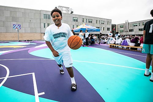 MIKAELA MACKENZIE / FREE PRESS
	
Michael Ghebrehiwet, 13, plays on the new basketball surface at Gordon Bell High School on Friday, Sept. 25, 2026.

For Maggie story.
Free Press 2026
