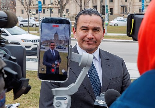 Premier Wab Kinew’s social media staff use an iPhone to capture his scrum with the media after speaking at the National Day of Mourning event at the Workers Memorial in Memorial Park in April . (Mike Deal/Winnipeg Free Press files)