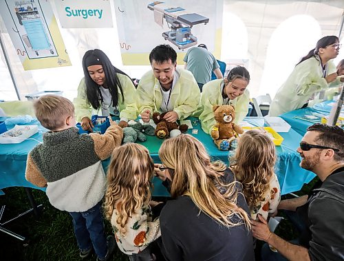 JOHN WOODS / FREE PRESS
Volunteer nurses Jonessa Balaswit, from left, Danny Lam and Tammy Phan care for some stuffed toys at the Teddy Bear Picnic at Assiniboine Park in Winnipeg, Sunday, September 27, 2026. 

reporter: standup