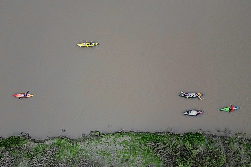 Kayakers and canoeists paddle up the Assiniboine River west of 18th Street North in Brandon during a sunset cruise group paddle as part of Paddlefest 2026 at the Riverbank Discovery Centre on Saturday.
(Tim Smith/The Brandon Sun)