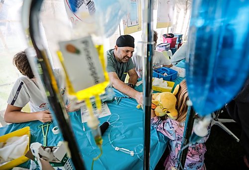 JOHN WOODS / FREE PRESS
Surgeon Lawrence Gillman cares for some stuffed toys at  the Teddy Bear Picnic at Assiniboine Park in Winnipeg, Sunday, September 27, 2026. 

reporter: standup