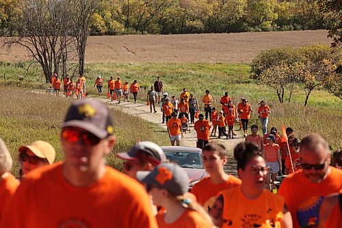 Participants in the 2025 Truth and Reconciliation Week Orange Shirt Day Walk make their way to the site of the former Brandon Indian Residential School. Participants were given offerings to leave at the school site and listened to speeches from elders and dignitaries and took part in events including a round dance. (Tim Smith/The Brandon Sun files)