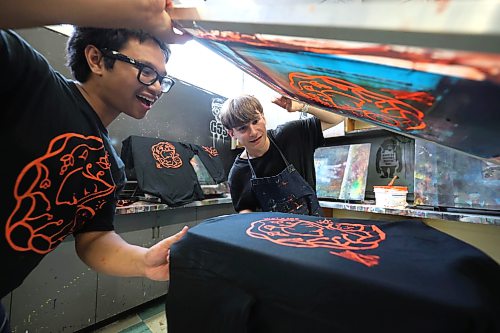 Ruth Bonneville / Free Press
LOCAL - TRC shirts
Elmwood High School students Daniel Concepcion in Grade 12 (glasses) and Lexington Zastre in grade 10 of the shops program, work together screen printing TRC shirts during their class at Elmwood High School (headquarters/shops for Elmwood Supply Co.) on Monday.
Story: TRC SCHOOLS: A high school student-run biz, Elmwood Supply Co is printing 800+ TRC designs on black t-shirts with logos of an Elmwood High alum's design for Orange Shirt Day. The group secured a grant from WSD to distribute shirts to every single student.
See story by Maggie
Sept 28th, 2026