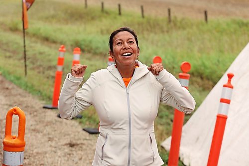 Cecile Murdock of Pinaymootang First Nation celebrates while reaching the finish line in Saturday's run. (Tim Smith/The Brandon Sun)