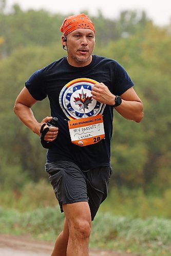 Luther Alexander of Pine Creek First Nation and Winnipeg runs through the prairie while taking part in Saturday's run. Alexander was the first runner to cross the finish line. (Tim Smith/The Brandon Sun)