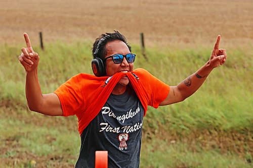 A runner celebrates while reaching the finish line in the fifth annual Reconciliation Run half marathon from the former Birtle Residential School site to Birdtail Sioux First Nation on Saturday. (Tim Smith/The Brandon Sun)