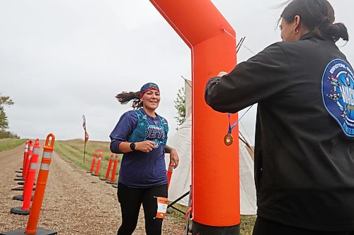 28092026
Samantha Powderhorn of Tadoule Lake crosses the finish line where Chief Tréchelle Bunn of Birdtail Sioux First Nation prepares to award her a medal during the fifth annual Reconciliation Run half marathon from the former Birtle Residential School site to Birdtail Sioux First Nation on Saturday.
(Tim Smith/The Brandon Sun)