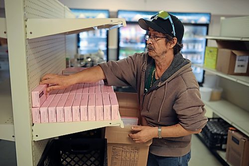 Volunteer Arthur North stocks shelves inside the Food Rescue Grocery Store’s new location at the former Prairie Oasis Centre on Eighth Street in Brandon on Thursday. (Tim Smith/The Brandon Sun)