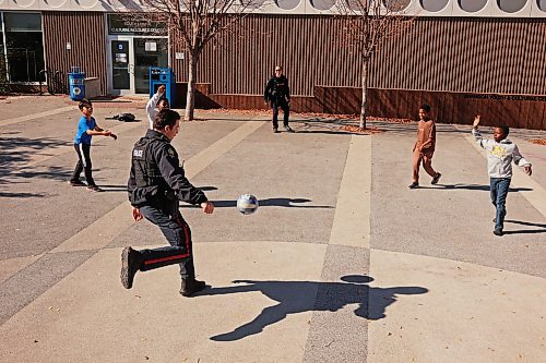 26092026
Brandon Police Service officers Cst. Fabian Toews and Cst. Jerra Green play soccer with kids on their school lunch break outside the A.R. McDiarmid Civic Complex in Brandon on a sunny Thursday. 
(Tim Smith/The Brandon Sun)