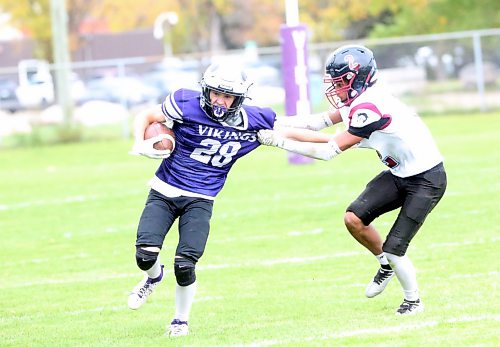Vikings running back Ethan Smith fights off a tackle by Irish D'Angelo. Smith scored a rushing and a receiving touchdown for Vincent Massey during the game (Rowan McCarthy/The Brandon Sun).