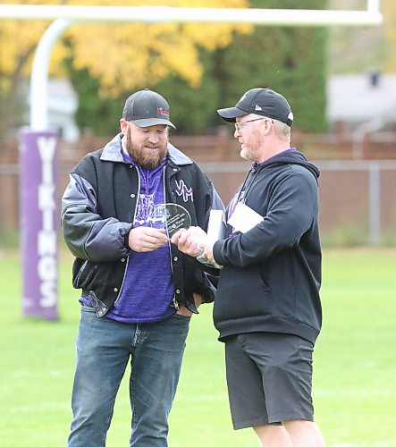 Mitchell Ficek (Left) receives an award from Vincent Massey head coach Mike Steeves to commemorate his induction into the Vincent Massey Vikings hall of fame (Rowan McCarthy/The Brandon Sun).
