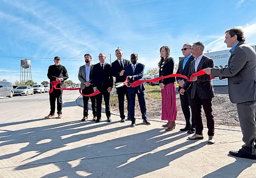MATTHEW FRANK / FREE PRESS
Alberta-based Olexa Developments and Winnipeg’s Shindico Realty Inc. held a ribbon-cutting ceremony on Monday to unveil the names of two completed streets running through the area and mark the start of building construction of the Water Tower District.
One of the new roads connecting the community to St. Boniface will honour Ibrahima Diallo, seen here cutting the ribbon, a Senegalese-born professor at Université de Saint-Boniface.