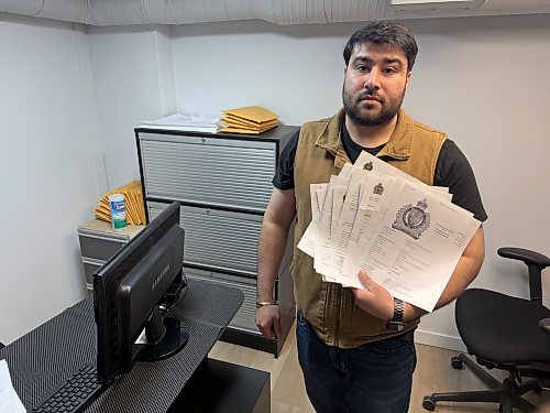 MORGAN MODJESKI / FREE PRESS
Mridul Vohra, owner of Freshslice Pizza at the intersection of Osborne Street and River Avenue, holds up a stack of police reports he's filed over recent months in the eatery's office on Oct. 6, 2026. He said this is only a small portion of the reports filed and hopes more police resources are dedicated to Osborne Village. 